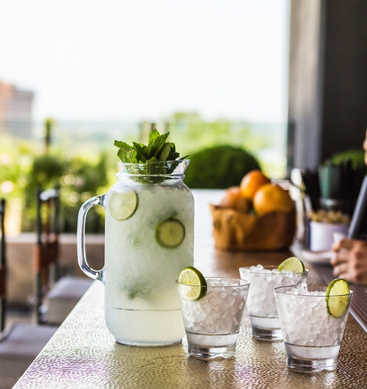 bartender mixing cocktails on rooftop bar