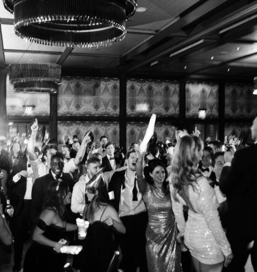 Guests dancing on dance floor.