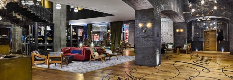 A spacious hotel lobby with modern decor and seating areas.