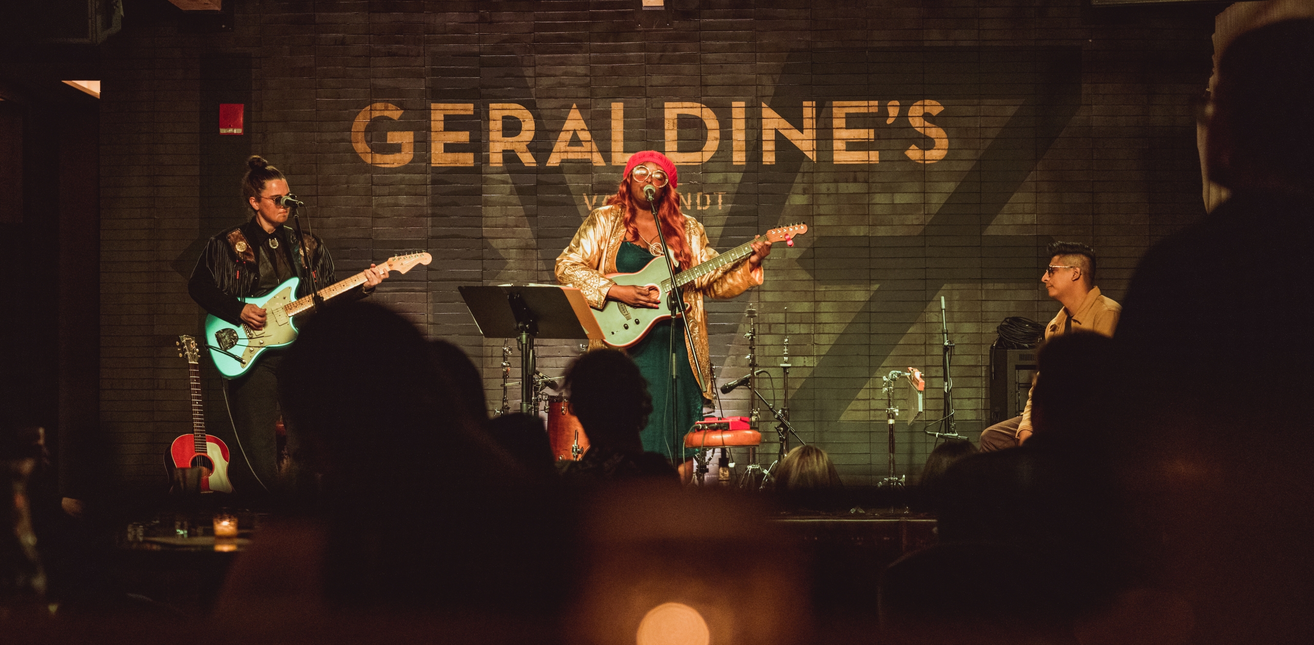A band performing onstage at the Gerardines.