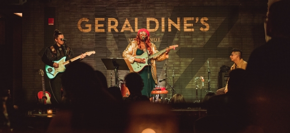 A band performing onstage at the Gerardines.