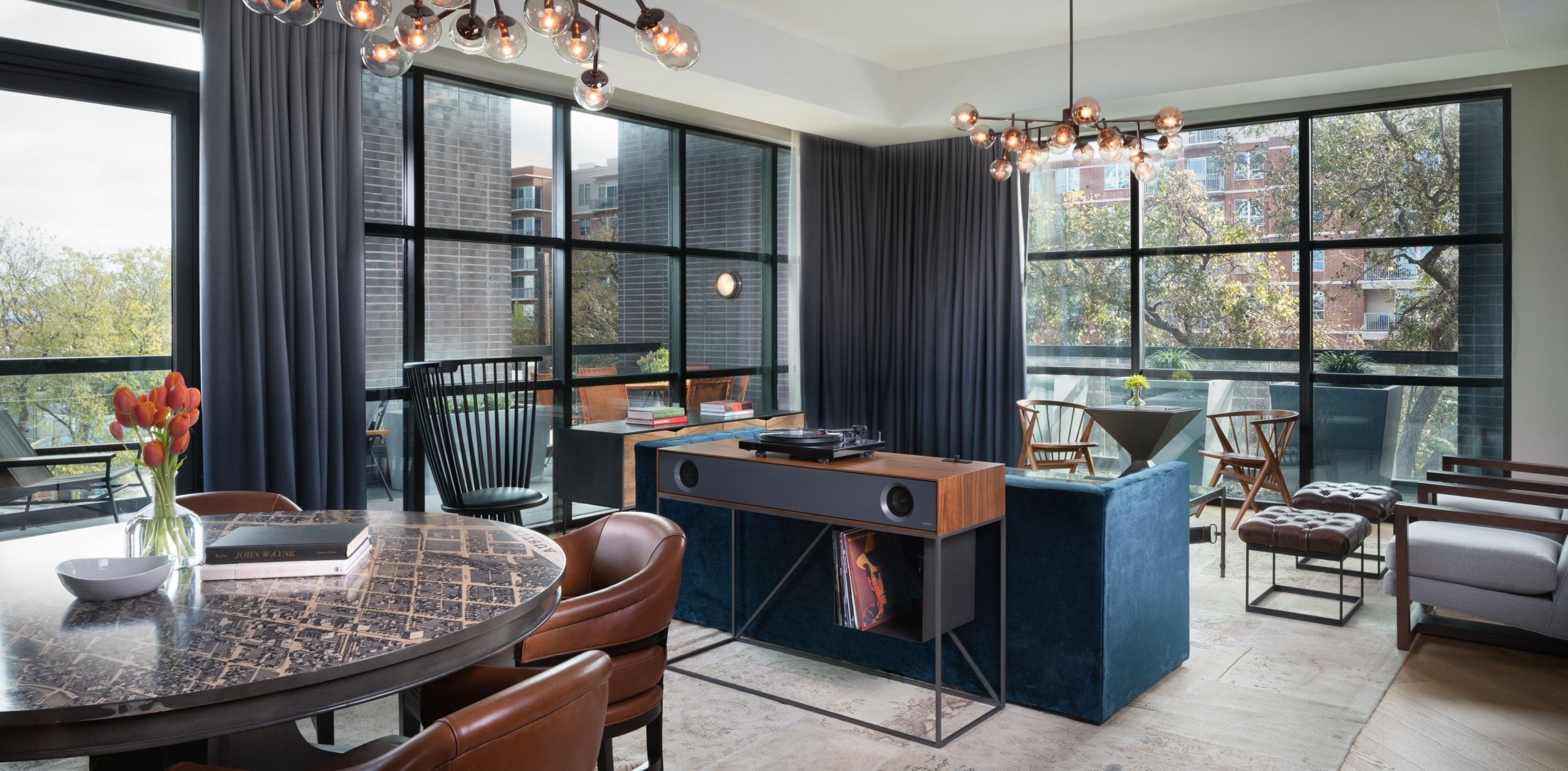 Rainey Suite with window views, blue couch and dining table
