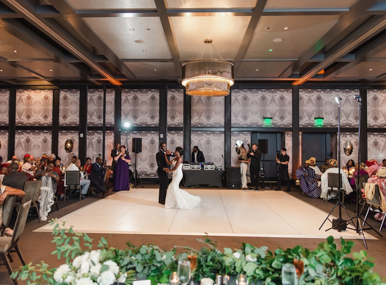 A large event space with a dance floor and seated guests.