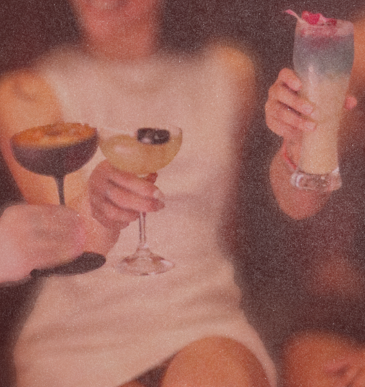 Friends toasting their cocktails at brunch.