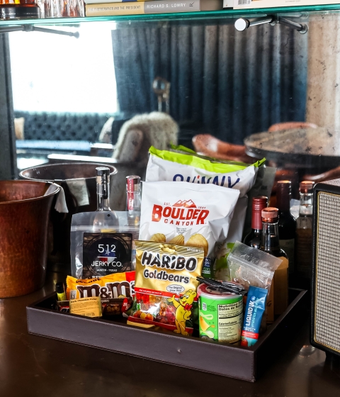 A tray of snacks and beverages in a hotel setting.