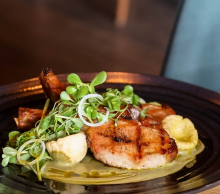 Grilled pork chop entree plated at Geraldine's