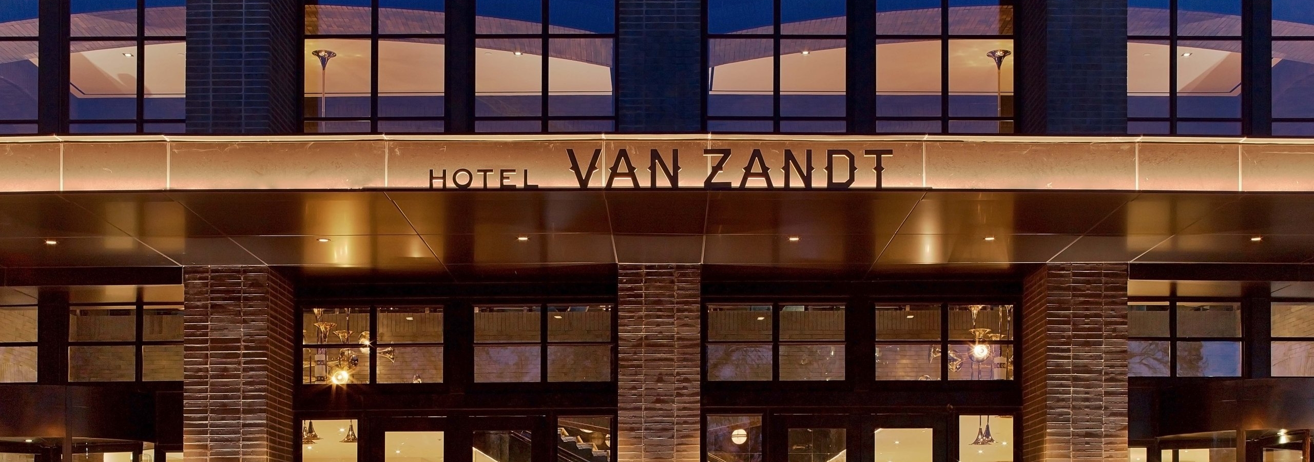 Hotel Van Zandt entrance lit up at night in Austin