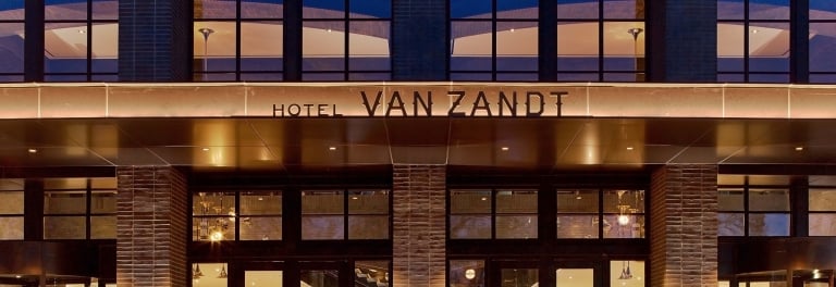 Hotel Van Zandt entrance lit up at night in Austin