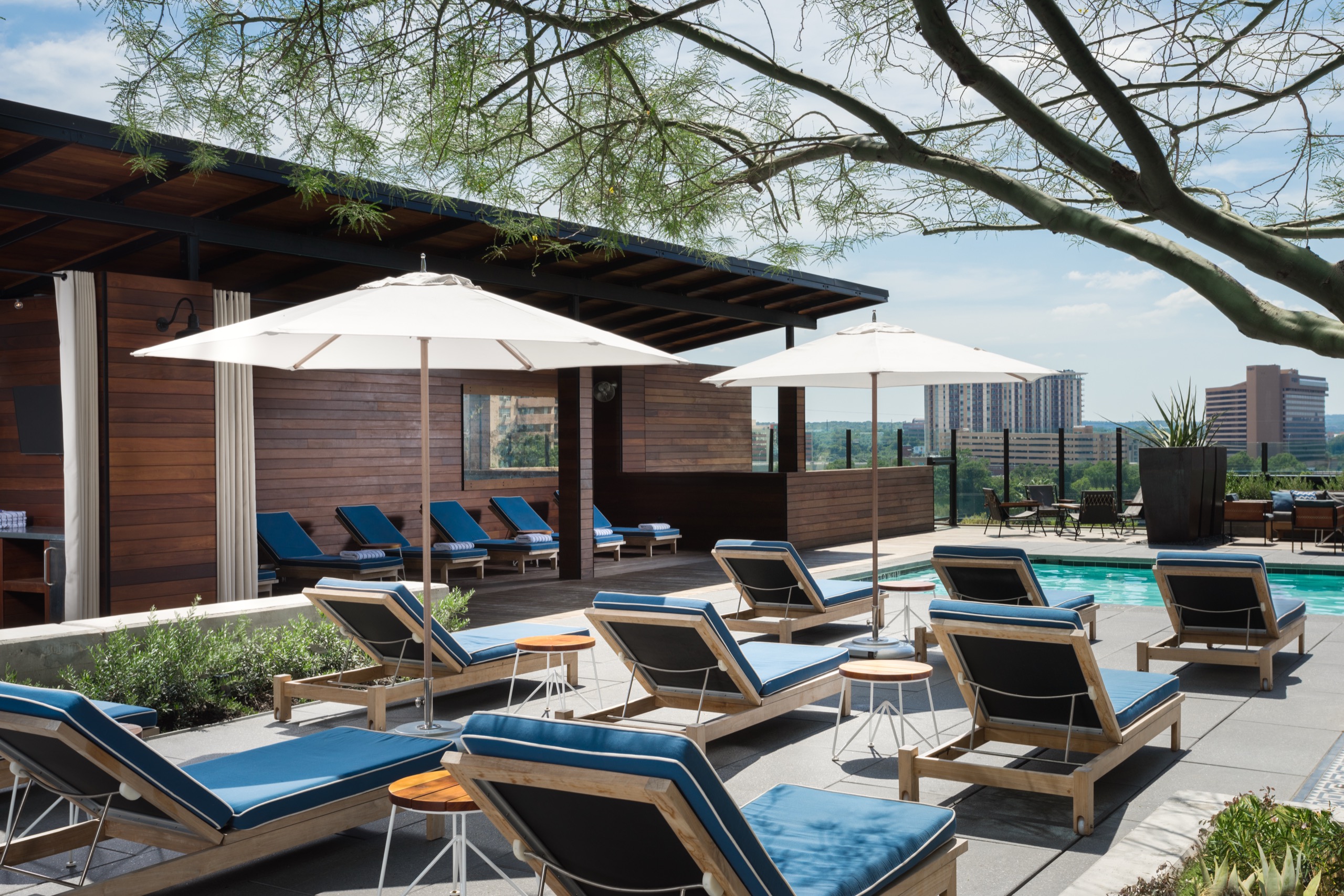 A poolside area with lounge chairs and umbrellas