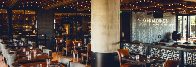 Barrel-vaulted dining room strung with Edison bulbs at Geraldine's, Hotel Van Zandt
