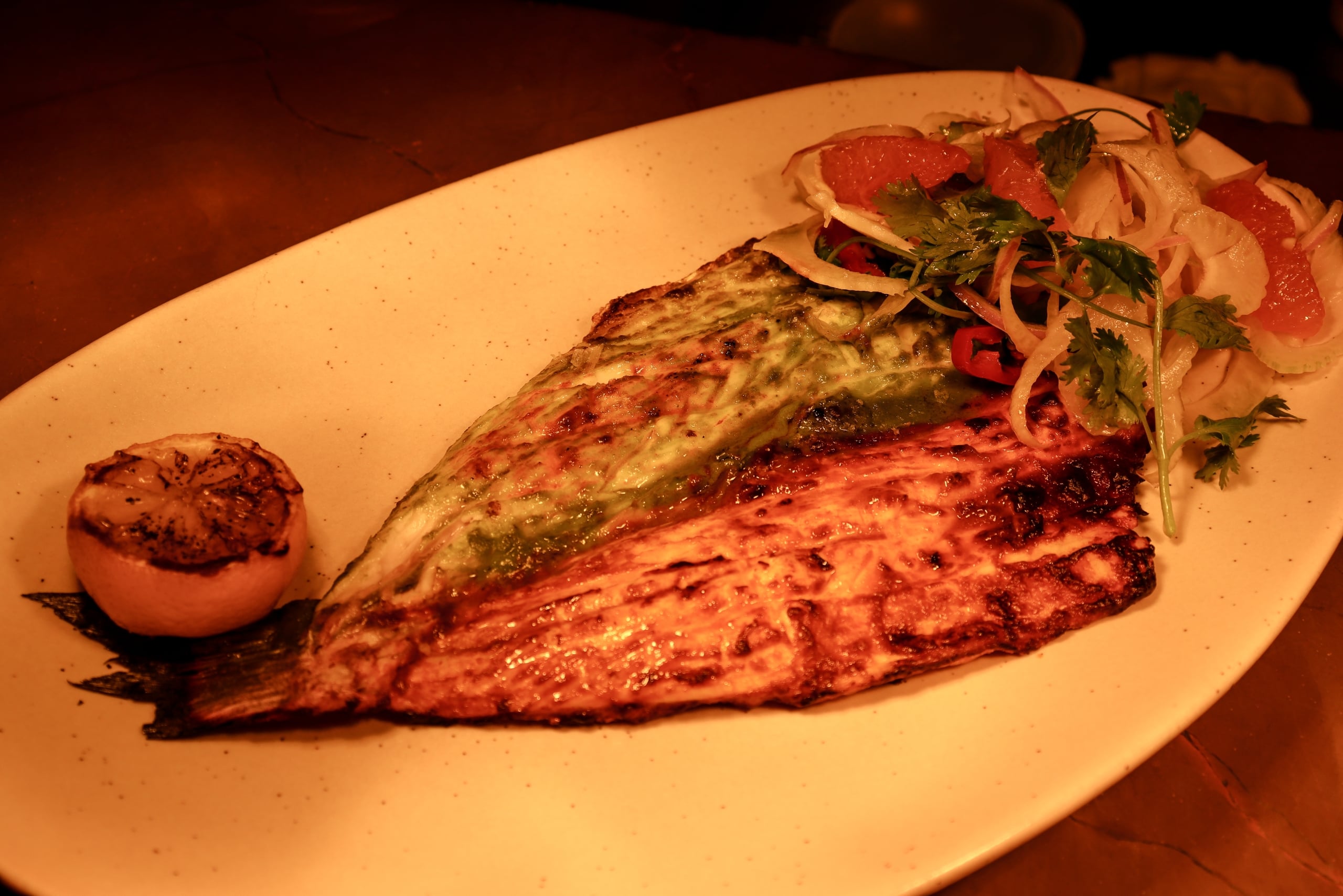 Whole grilled branzino a la talla with charred citrus and a fennel and grapefruit salad