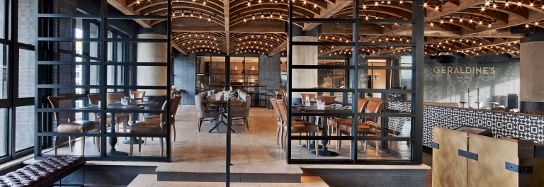 Geraldine's restaurant interior at Hotel Van Zandt with arched wood beam ceiling and Edison lights